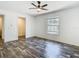 This bedroom features a ceiling fan, a window, and wood-look flooring at 18079 Carrolwood Dr, Brooksville, FL 34604