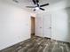Clean bedroom featuring wood-look floors, a ceiling fan and closet at 18079 Carrolwood Dr, Brooksville, FL 34604