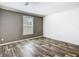 Neutral bedroom with a large window and wood-look flooring at 18079 Carrolwood Dr, Brooksville, FL 34604