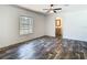 Spacious bedroom featuring wood-look floors and a window at 18079 Carrolwood Dr, Brooksville, FL 34604