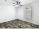 Cozy bedroom featuring plank flooring, fresh paint, ceiling fan and natural light at 18079 Carrolwood Dr, Brooksville, FL 34604