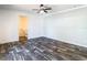 This bedroom features wood-look floors and an open bathroom at 18079 Carrolwood Dr, Brooksville, FL 34604