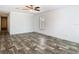 This bedroom features wood-look floors and an open hallway at 18079 Carrolwood Dr, Brooksville, FL 34604