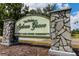 Stone pillars flank the entrance sign to The Homes at Sylvan Grove, an adult land owned community at 18079 Carrolwood Dr, Brooksville, FL 34604