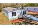 Exterior shot of the house showing clean white siding, dark shutters, and a well-maintained yard at 18079 Carrolwood Dr, Brooksville, FL 34604