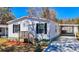 Charming home with white siding, black shutters, and a covered carport for convenient parking at 18079 Carrolwood Dr, Brooksville, FL 34604