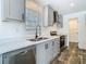 Kitchen with stainless steel appliances, grey cabinets, plenty of counter space and a double sink at 18079 Carrolwood Dr, Brooksville, FL 34604