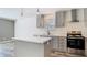 Bright kitchen features gray cabinets, stainless steel appliances, and a kitchen island at 18079 Carrolwood Dr, Brooksville, FL 34604