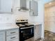 Modern kitchen featuring gray cabinets, quartz countertops, stainless steel appliances, and pantry at 18079 Carrolwood Dr, Brooksville, FL 34604