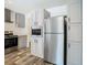 The kitchen has stainless steel appliances, gray cabinets, ample counter space, and luxury vinyl plank flooring at 18079 Carrolwood Dr, Brooksville, FL 34604