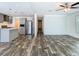 Bright and airy living room with modern light fixtures, luxury vinyl plank floors, and neutral paint at 18079 Carrolwood Dr, Brooksville, FL 34604