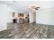 Open concept living room and kitchen with gray cabinets, stainless appliances, and luxury vinyl plank flooring at 18079 Carrolwood Dr, Brooksville, FL 34604