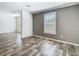 Bright living room featuring plank flooring, fresh paint and lots of natural light at 18079 Carrolwood Dr, Brooksville, FL 34604