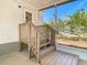 A screened porch features wood stairs, rails and flooring and a view of foliage at 18079 Carrolwood Dr, Brooksville, FL 34604