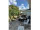 Rear view of house with paver patio, golf cart, palm trees, seating and grill at 1902 Dandridge St # 6, Sun City Center, FL 33573