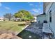 Inviting backyard featuring a stone patio, mature trees, and well-maintained lawn at 1902 Dandridge St # 6, Sun City Center, FL 33573