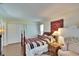 Comfortable bedroom with a decorative area rug, a beautiful red rose painting and a four-poster bed at 1902 Dandridge St # 6, Sun City Center, FL 33573