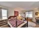 Spacious bedroom featuring a four-poster bed, two large windows and a decorative area rug at 1902 Dandridge St # 6, Sun City Center, FL 33573