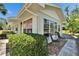 Charming white home with lush landscaping and a brick walkway leading to outdoor seating at 1902 Dandridge St # 6, Sun City Center, FL 33573