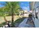 Exterior view of a home featuring tropical landscaping and a brick walkway with outdoor seating at 1902 Dandridge St # 6, Sun City Center, FL 33573