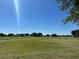 Picturesque golf course with manicured greens, mature trees and blue sky background at 1902 Dandridge St # 6, Sun City Center, FL 33573