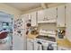 Kitchen with white appliances, wooden cabinets, and adjacent dining area at 1902 Dandridge St # 6, Sun City Center, FL 33573