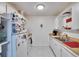 Galley kitchen with white cabinets, wood countertops, and tiled floors at 1902 Dandridge St # 6, Sun City Center, FL 33573