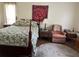 Bedroom with four-poster bed, floral bedding, wood floors, and a round rug at 1902 Dandridge St # 6, Sun City Center, FL 33573