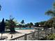 Community pool surrounded by comfortable seating, palm trees, and lush landscaping at 1902 Dandridge St # 6, Sun City Center, FL 33573