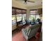Enclosed sunroom with multiple windows providing lots of natural light and two comfortable recliner chairs at 1902 Dandridge St # 6, Sun City Center, FL 33573