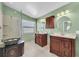 Elegant bathroom with double vanities, updated fixtures, a glass shower, and modern finishes at 1996 Promenade Way, Clearwater, FL 33760