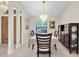 Formal dining room with chandelier lighting, dark wood furnishings, and tiled flooring at 1996 Promenade Way, Clearwater, FL 33760