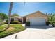 Charming single-story home featuring a well-manicured lawn and attached two-car garage at 1996 Promenade Way, Clearwater, FL 33760