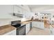 Kitchen with stainless steel appliances, granite countertops, and white cabinets offers ample space at 1996 Promenade Way, Clearwater, FL 33760