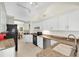 Updated kitchen features granite countertops, stainless steel appliances, and ample storage space at 1996 Promenade Way, Clearwater, FL 33760
