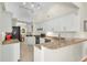 Well-lit kitchen with granite countertops and stainless steel appliances is perfect for cooking at 1996 Promenade Way, Clearwater, FL 33760