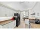 Bright kitchen features granite counters, stainless appliances, white cabinets, and ample counter space at 1996 Promenade Way, Clearwater, FL 33760