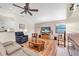 Inviting living room features a ceiling fan, comfortable seating, and a cozy fireplace at 1996 Promenade Way, Clearwater, FL 33760