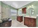 Stylish main bathroom featuring a glass enclosed shower, tiled floor, and dual sink vanity at 1996 Promenade Way, Clearwater, FL 33760