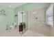 Well-lit bathroom with tiled shower, toilet, vanity, tiled floor, and custom decorations at 1996 Promenade Way, Clearwater, FL 33760