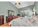 Comfortable main bedroom with vaulted ceiling, ceiling fan and view to the backyard pool at 1996 Promenade Way, Clearwater, FL 33760