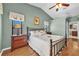 Well-lit main bedroom with vaulted ceiling, ceiling fan, hardwood flooring, and light green walls at 1996 Promenade Way, Clearwater, FL 33760