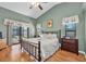 Comfortable main bedroom with pool view, vaulted ceiling, ceiling fan and beautiful natural light at 1996 Promenade Way, Clearwater, FL 33760