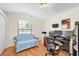 Bright office space with hardwood floors, a large window, and a functional workstation setup for working from home at 1996 Promenade Way, Clearwater, FL 33760