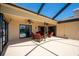 Enjoy this covered patio with ceiling fans and plenty of seating for entertaining at 1996 Promenade Way, Clearwater, FL 33760