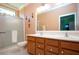 Bathroom featuring a double vanity, large mirror, and a glass-enclosed shower at 221 Shell Falls Dr, Apollo Beach, FL 33572