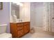 Bathroom showcasing wooden vanity, and shower-tub combination with updated fixtures at 221 Shell Falls Dr, Apollo Beach, FL 33572
