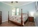 Light-filled bedroom features a four-poster bed and an end table with a lamp at 221 Shell Falls Dr, Apollo Beach, FL 33572