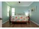 Well-lit bedroom with a four-poster bed and tropical floral bedding at 221 Shell Falls Dr, Apollo Beach, FL 33572