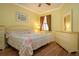 Bright bedroom with yellow walls, wooden floors, a ceiling fan and classic furnishings at 221 Shell Falls Dr, Apollo Beach, FL 33572